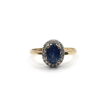 18ct yellow gold sapphire and diamond ring with a central blue sapphire and sparkling diamonds, elegant jewelry piece.