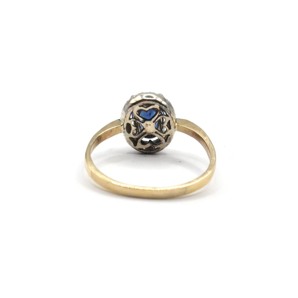 18ct yellow gold sapphire and diamond ring with a central blue sapphire and surrounding diamonds, elegant jewelry piece.