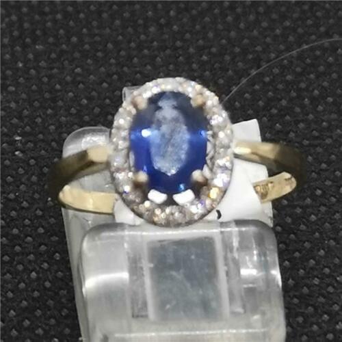 18ct yellow gold sapphire and diamond ring with a central blue sapphire and sparkling diamonds on a sleek band.