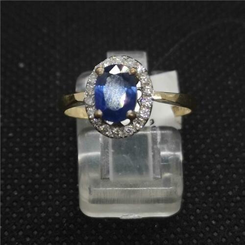 18ct yellow gold ring featuring a central sapphire gemstone surrounded by small diamonds, elegant and unbranded jewelry piece.