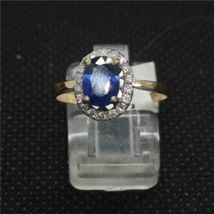 18ct yellow gold ring featuring a central sapphire gemstone surrounded by small diamonds, elegant and unbranded jewelry piece.
