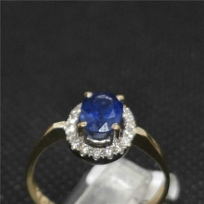 18ct yellow gold sapphire and diamond ring with elegant design, featuring a central blue sapphire and sparkling diamonds.