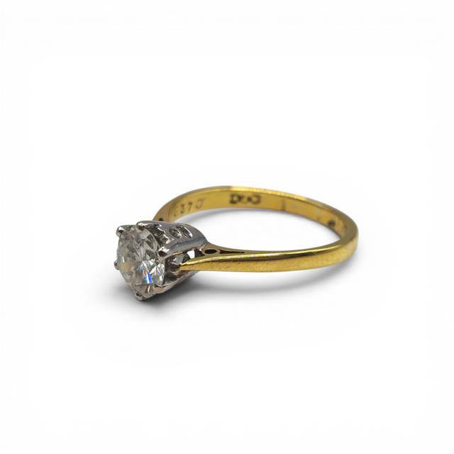 18ct yellow gold single diamond ring with a sleek band and a single sparkling diamond, showcasing elegant jewelry design.