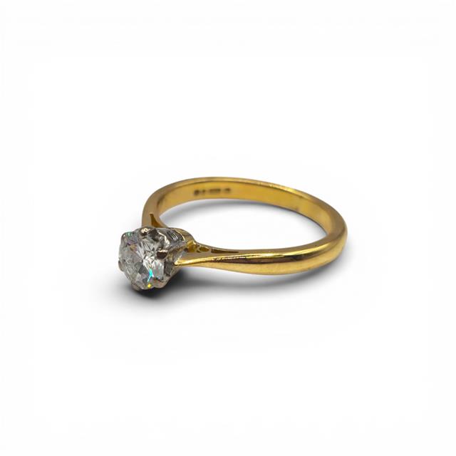 18ct yellow gold diamond ring with a single sparkling diamond stone, elegant unbranded jewelry piece.