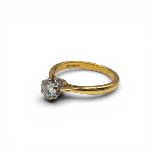 18ct yellow gold diamond ring with a single sparkling diamond stone, elegant unbranded jewelry piece.
