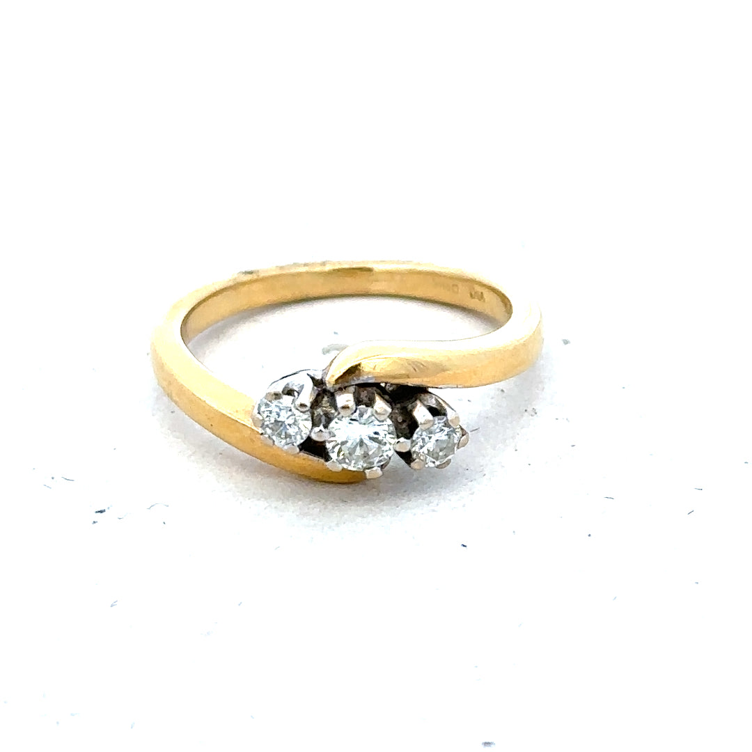 18ct yellow gold three-diamond ring with a sleek band, showcasing elegant craftsmanship and sparkling gemstone accents.