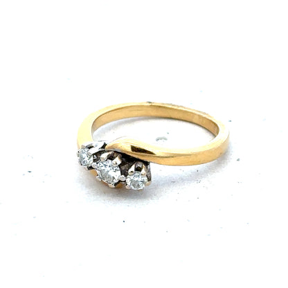 18ct yellow gold three-diamond ring with a sleek band, showcasing elegant sparkle and craftsmanship.