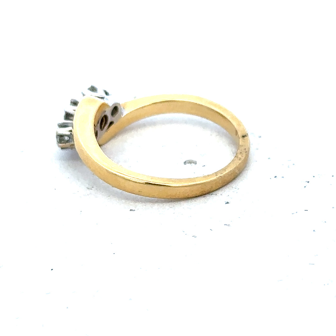 18ct yellow gold three-diamond ring with a sleek band, showcasing elegant brilliance and craftsmanship.