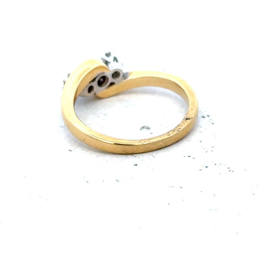 18ct yellow gold three-diamond ring with a sleek band, showcasing sparkling diamonds on a stylish jewelry piece.