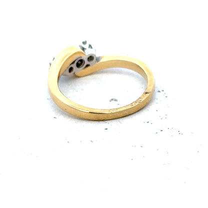 18ct yellow gold three-diamond ring with a sleek band, showcasing sparkling diamonds on a stylish jewelry piece.