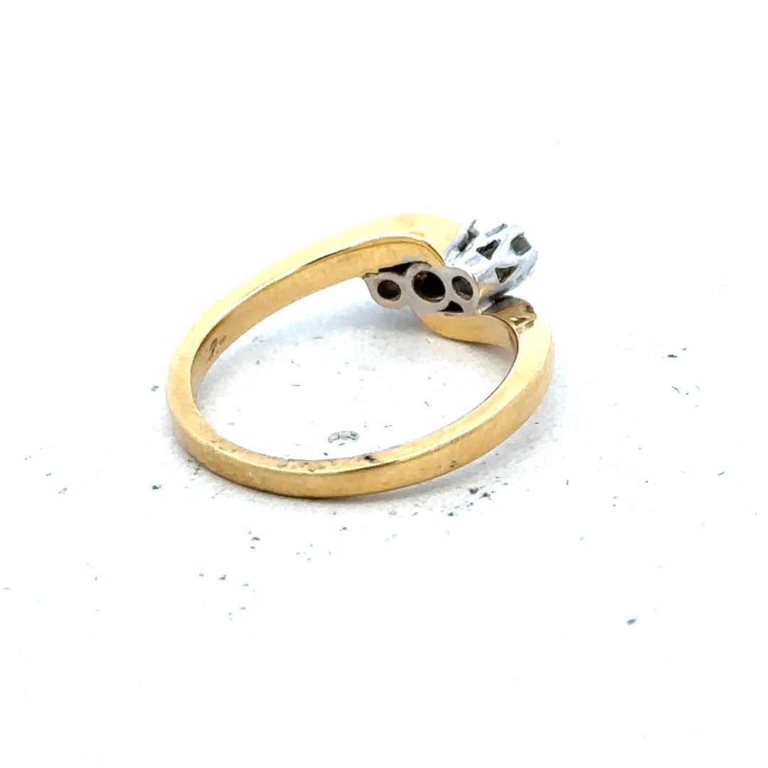 18ct yellow gold three-diamond ring, elegant jewelry piece with sparkling stones and smooth band, unbranded.