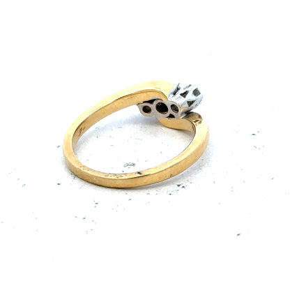 18ct yellow gold three-diamond ring, elegant jewelry piece with sparkling stones and smooth band, unbranded.