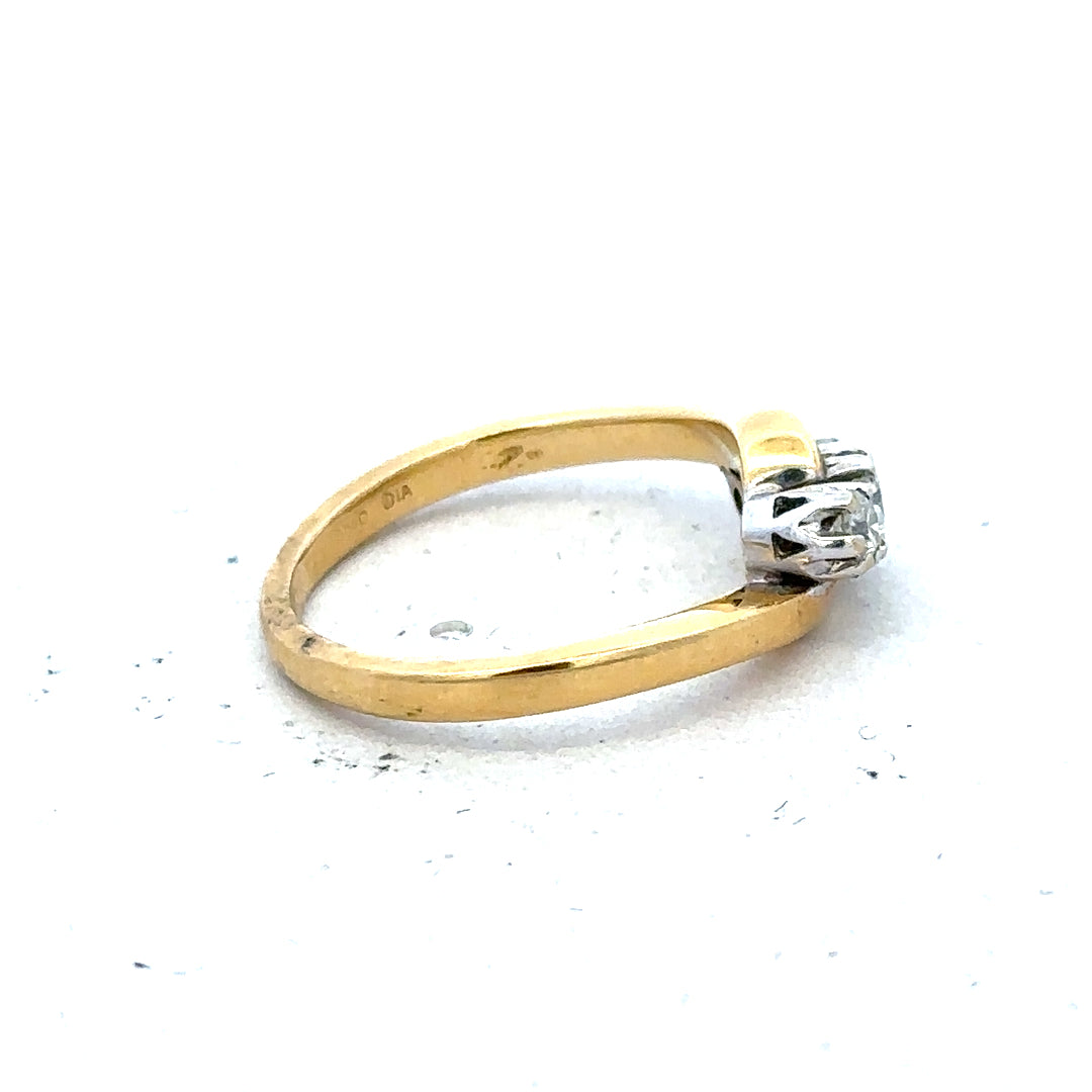 18ct yellow gold three diamond ring with a sleek band and sparkling diamonds, showcasing elegant jewelry design.