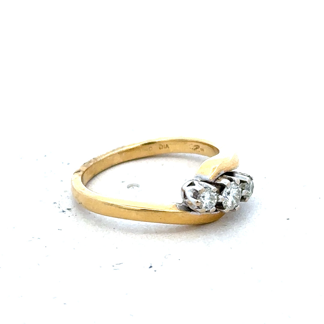 18ct yellow gold ring featuring three sparkling diamonds, elegant unbranded jewelry piece with a classic design.