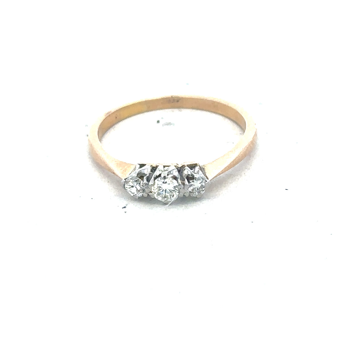 18ct yellow gold three diamond ring with a simple band and sparkling diamonds, showcasing elegant jewelry design.