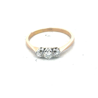 18ct yellow gold three diamond ring with a simple band and sparkling diamonds, showcasing elegant jewelry design.
