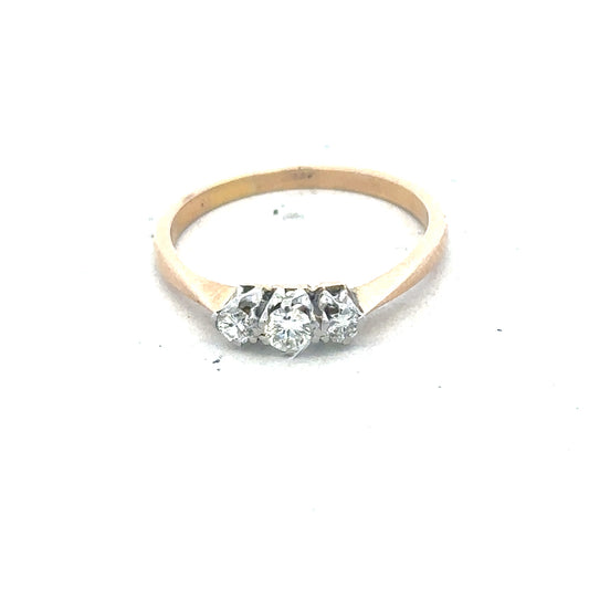 18ct yellow gold three diamond ring with a simple band and sparkling diamonds, showcasing elegant jewelry design.