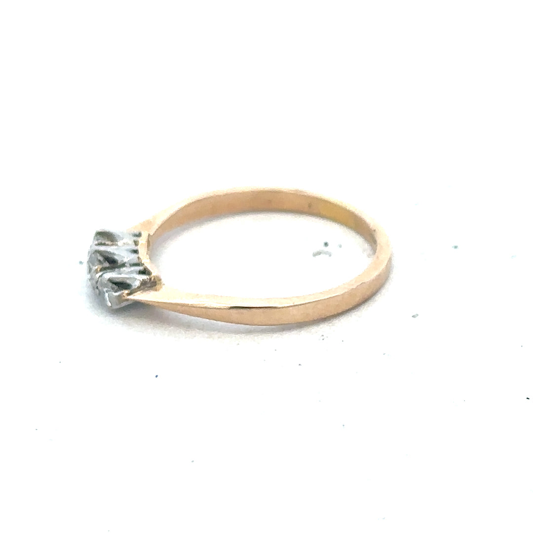 18ct yellow gold ring with three sparkling diamonds, showcasing elegant jewelry design and craftsmanship.