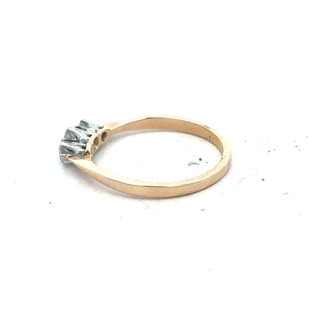 18ct yellow gold three diamond ring with a sleek band and sparkling diamonds, showcasing elegant jewelry design.