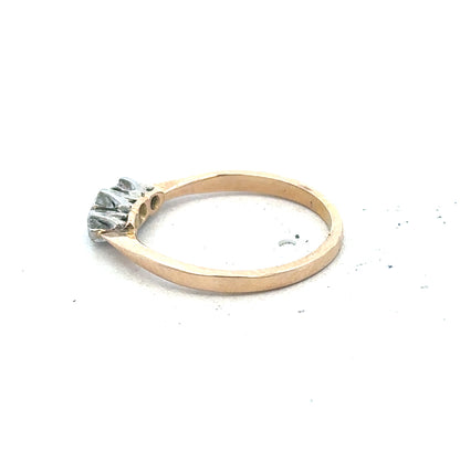 18ct yellow gold three diamond ring with a sleek band and sparkling diamonds, showcasing elegant jewelry design.
