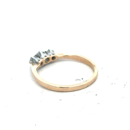 18ct yellow gold three diamond ring with a sleek band and sparkling diamonds, showcasing elegant jewelry design.