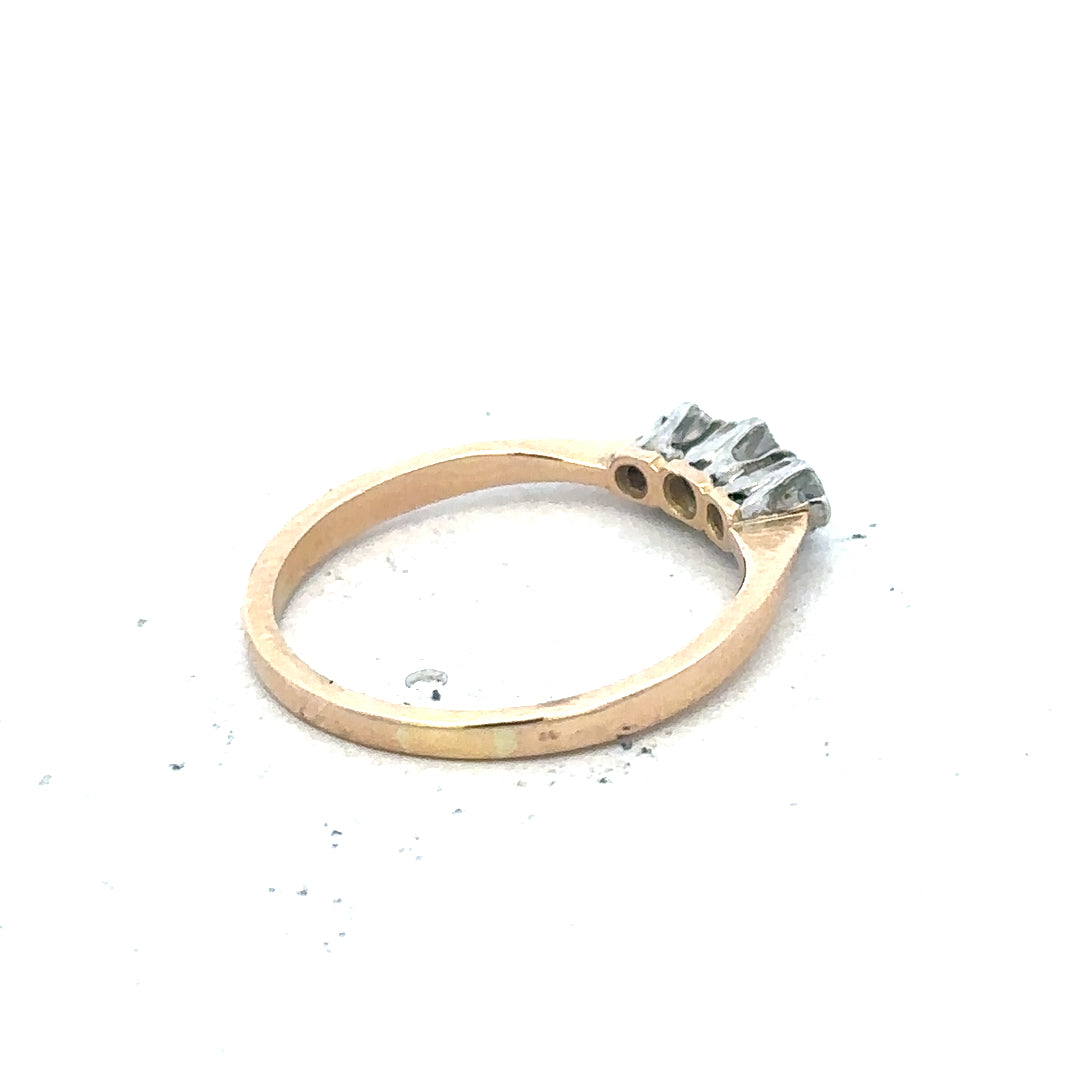 18ct yellow gold three diamond ring with a simple, elegant band and sparkling diamond accents.