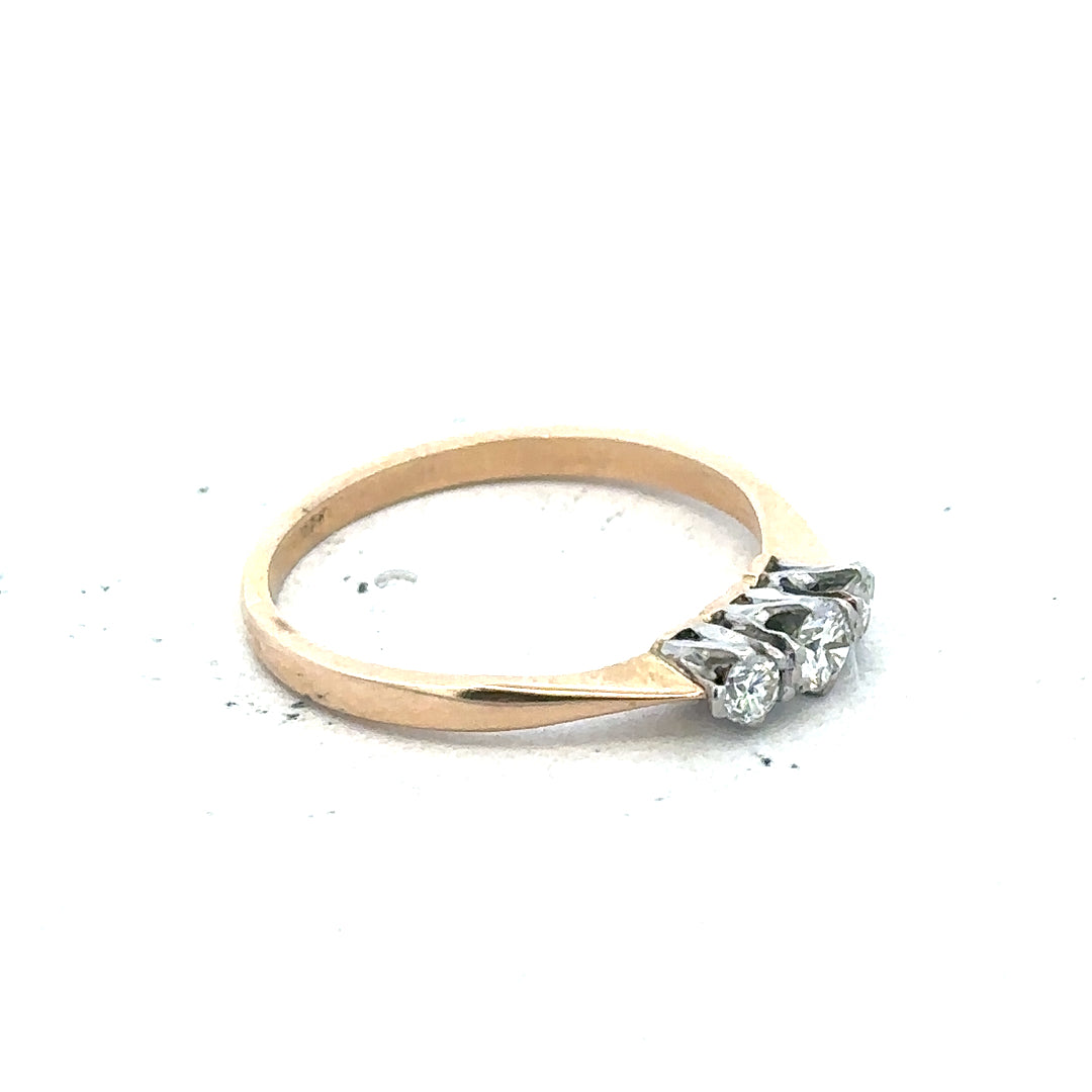 18ct yellow gold three diamond ring with a polished band and sparkling diamonds, showcasing elegant jewelry craftsmanship.