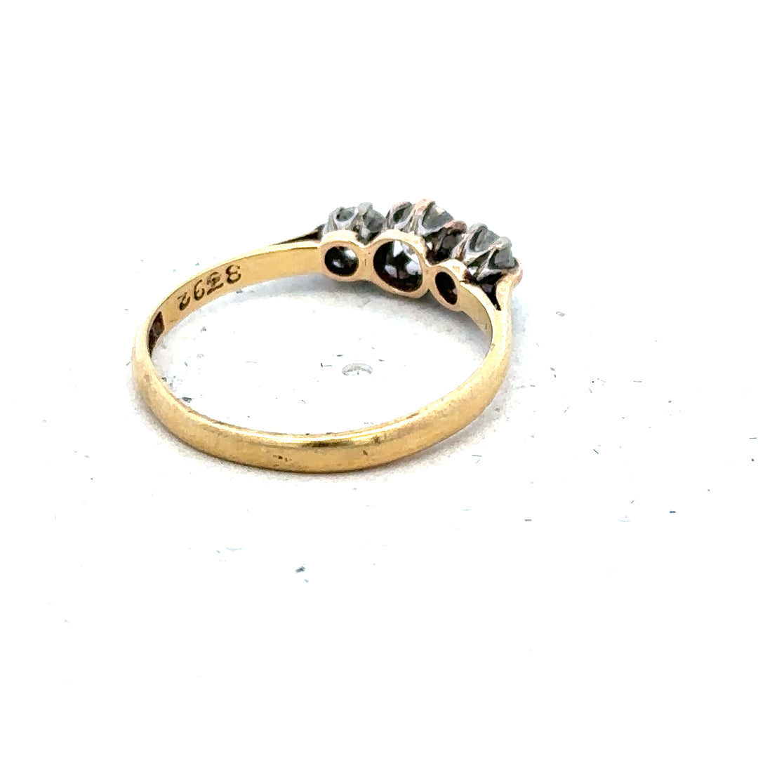 18ct yellow gold three diamond ring in size L, featuring a classic design with sparkling gemstones and a polished band.