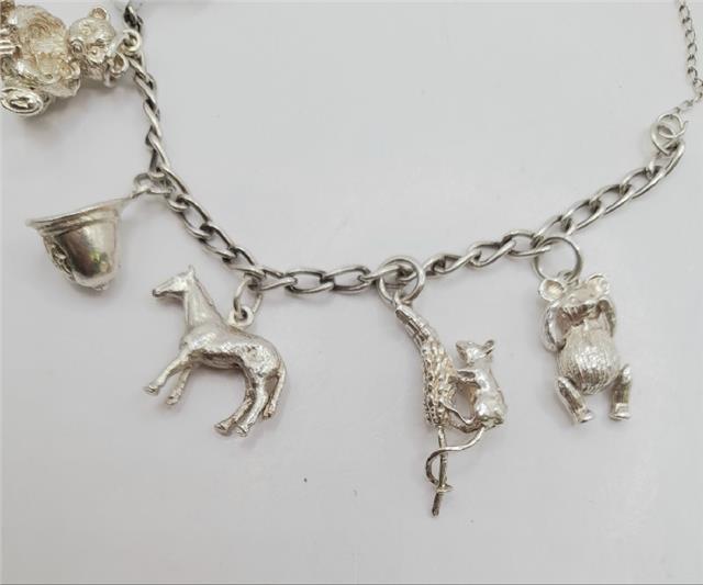 925 silver charm bracelet with intricate details, unbranded, weighing 27.3g, showcasing a stylish and elegant jewelry accessory.
