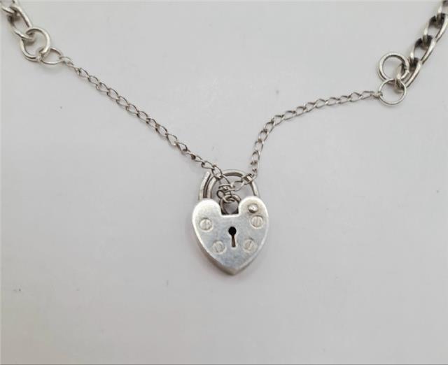 925 silver charm bracelet with intricate details, weighing 27.3g, featuring various charms and a polished finish.