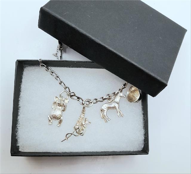 925 silver charm bracelet with intricate designs, unbranded, weighing 27.3g, showcasing detailed charms and polished silver finish.