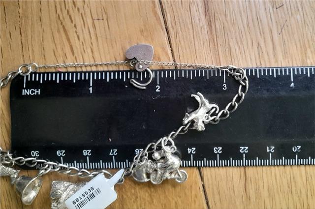 925 silver charm bracelet with intricate designs, weighs 27.3g, unbranded, featuring detailed craftsmanship and classic charm style.