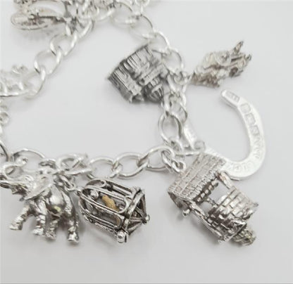 925 silver charm bracelet, unbranded, 7-inch length, 53.6g, detailed with various charms and intricate silver design.