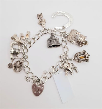 925 silver charm bracelet, unbranded, 7-inch length, weighs 53.6g, with detailed silver charm links and secure clasp.