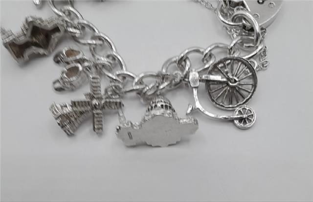 925 silver charm bracelet weighing 53.6g, 7-inch length, unbranded, featuring detailed silver charms and intricate design.