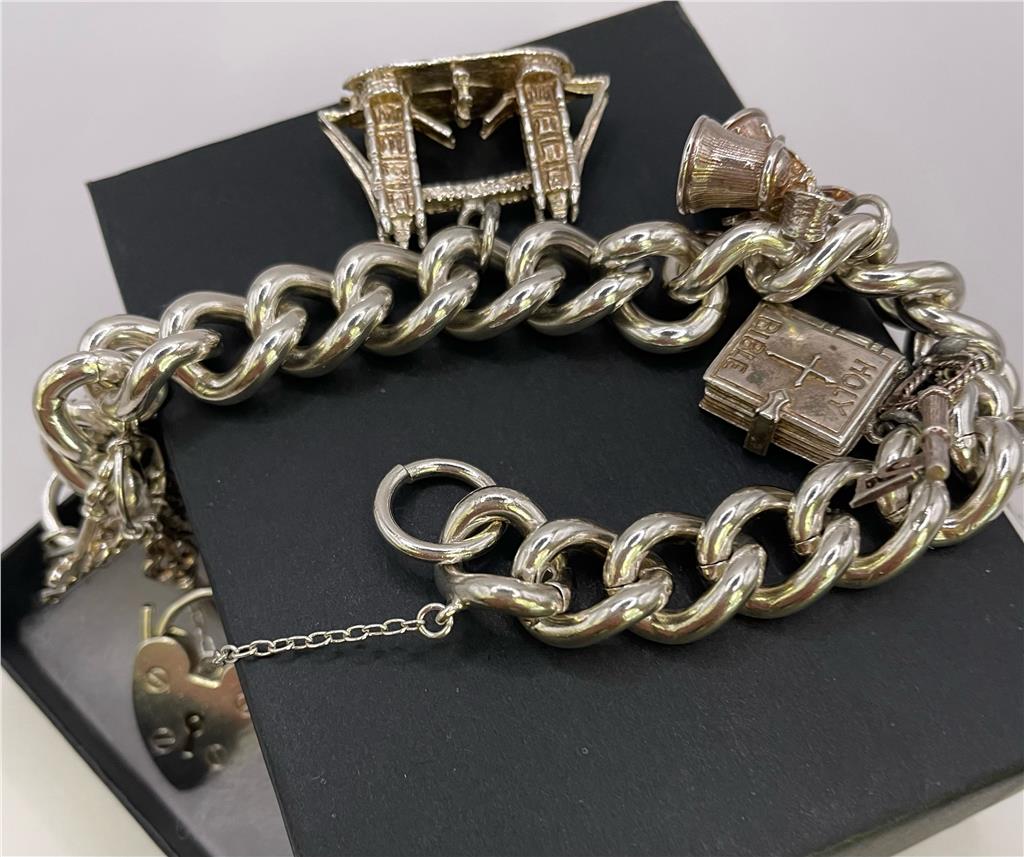 925 silver charm bracelet with intricate designs, featuring various charms and a secure clasp, unbranded jewelry accessory.