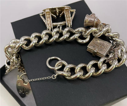925 silver charm bracelet with intricate designs, featuring various charms and a secure clasp, unbranded jewelry accessory.