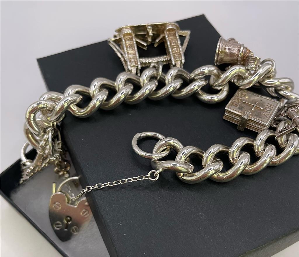 925 silver charm bracelet with intricate designs, featuring various charms and a secure clasp, unbranded jewelry accessory.