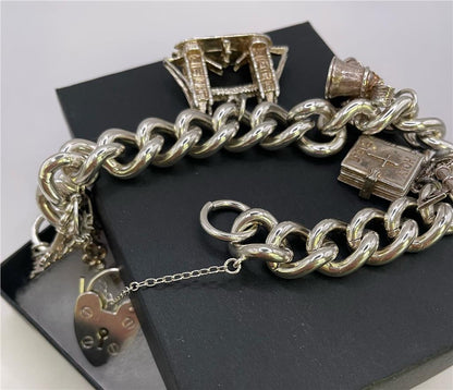 925 silver charm bracelet with intricate designs, featuring various charms and a secure clasp, unbranded jewelry accessory.