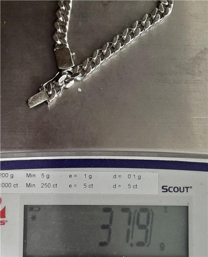925 silver curb bracelet, unbranded, 24cm length, 37.9g, detailed chain design, worn on wrist in close-up image.