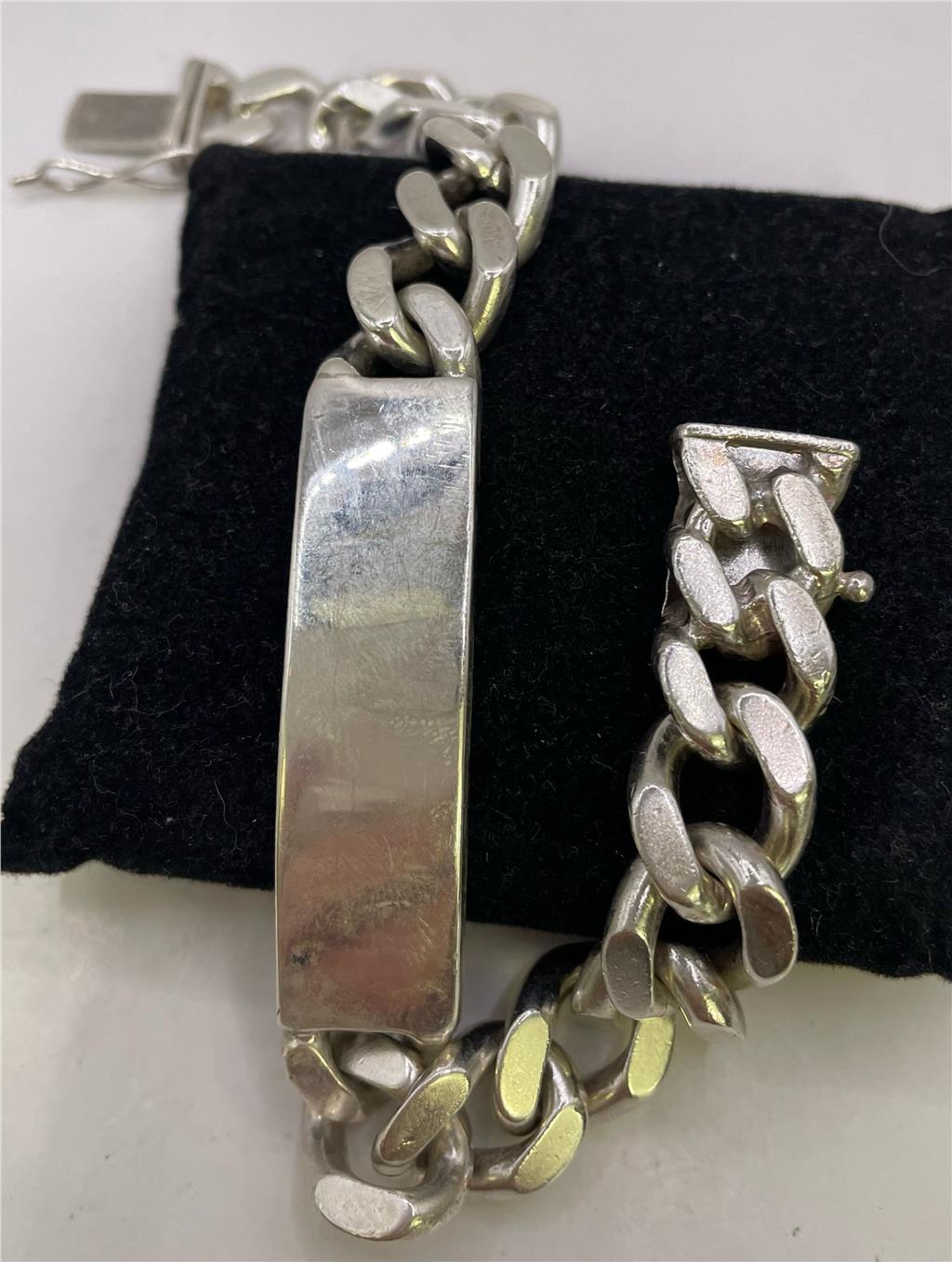 Silver ID bracelet made of 925 sterling silver with a sleek, polished finish, featuring a rectangular ID plate and chain links.