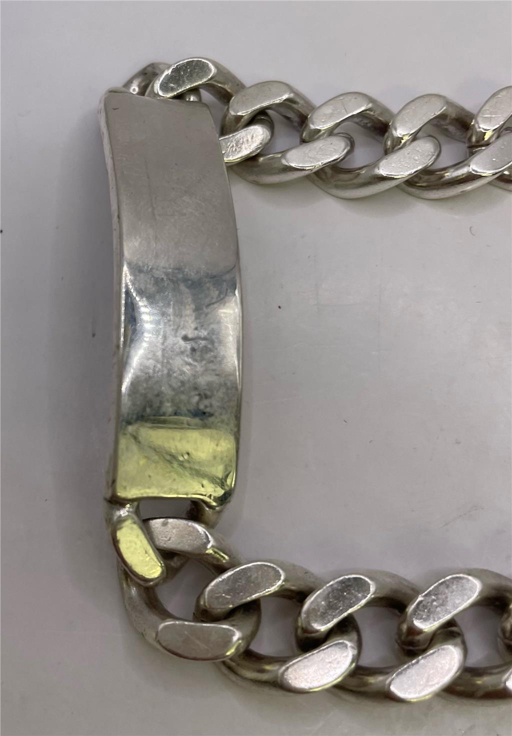 925 silver ID bracelet with a sleek, polished design, featuring a customizable ID plate on a silver chain.