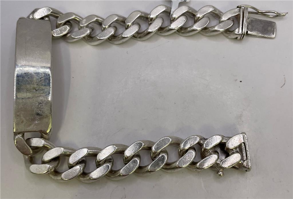 Silver ID bracelet with engraved plate, unbranded 925 sterling silver jewelry, showcasing a sleek, polished design.