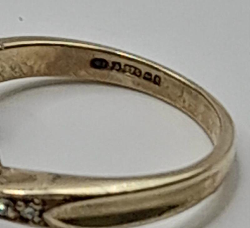 9ct diamond ring in size J1/2 with 2.8g weight, featuring sparkling diamonds and a sleek band design.