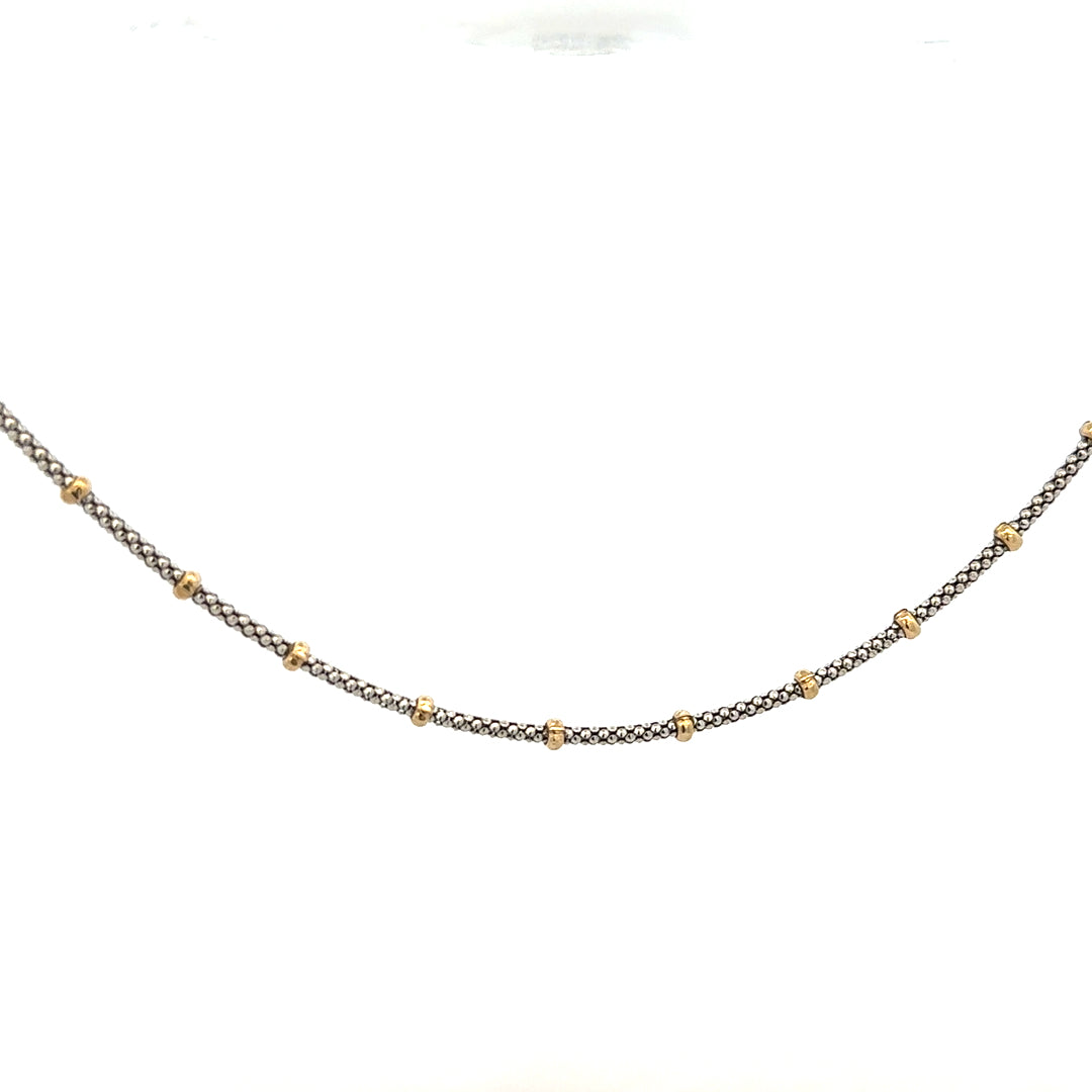 Close-up of a 9ct gold chain weighing 5.6g, featuring a classic link design, unbranded.