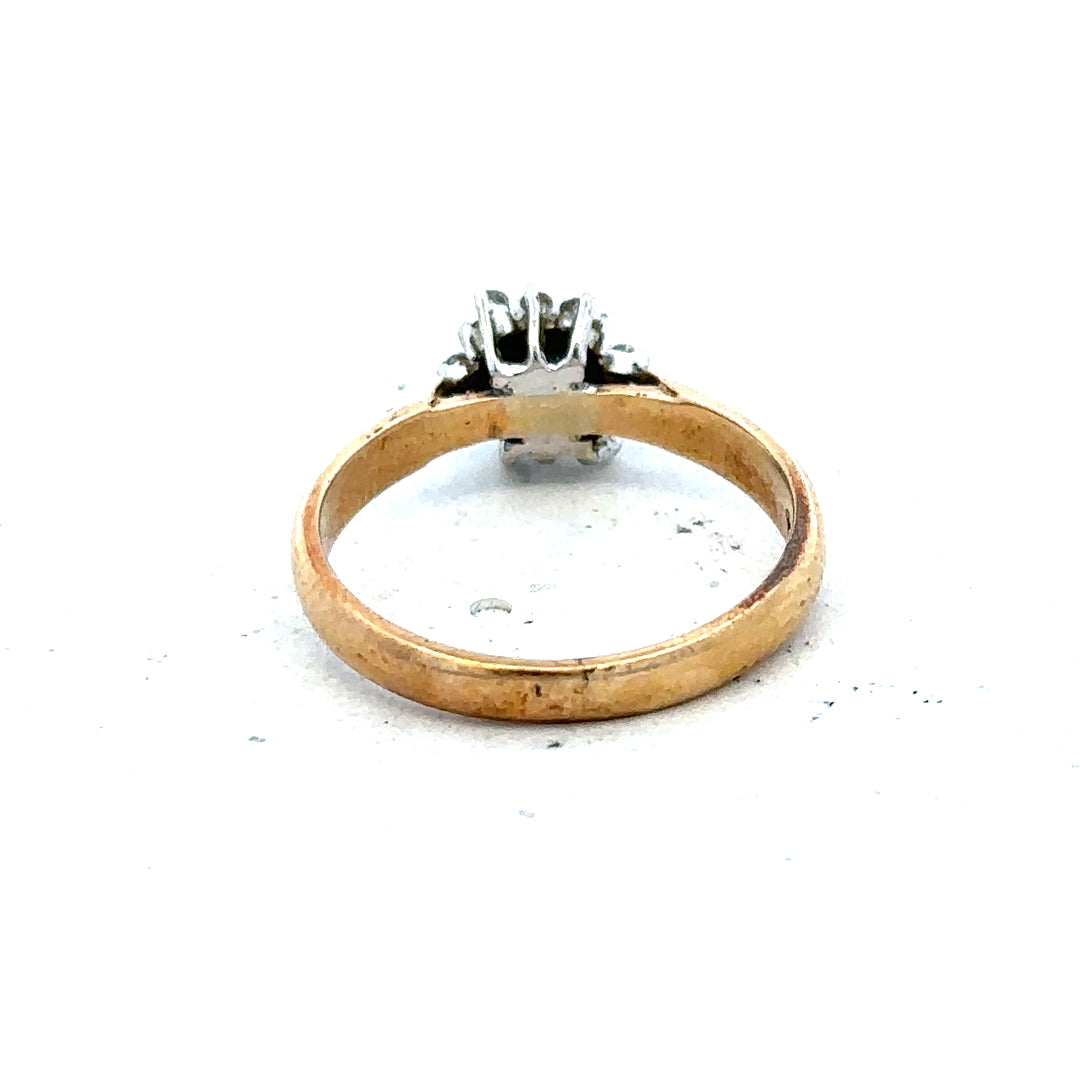 9ct gold diamond ring featuring a sparkling central diamond and a polished gold band, displayed on a neutral background