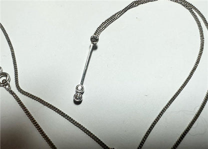 9ct white gold chain with an 18ct white gold diamond pendant, featuring sparkling diamonds and a delicate, elegant design.