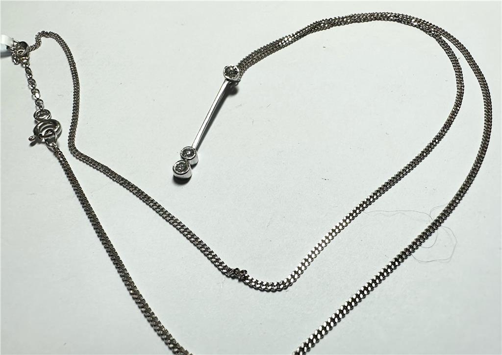 9ct white gold chain with 18ct white gold diamond pendant, featuring a sparkling diamond and elegant design.