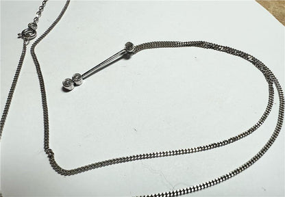 9ct white gold chain with 18ct white gold diamond pendant, showcasing a delicate jewelry set with sparkling diamonds.