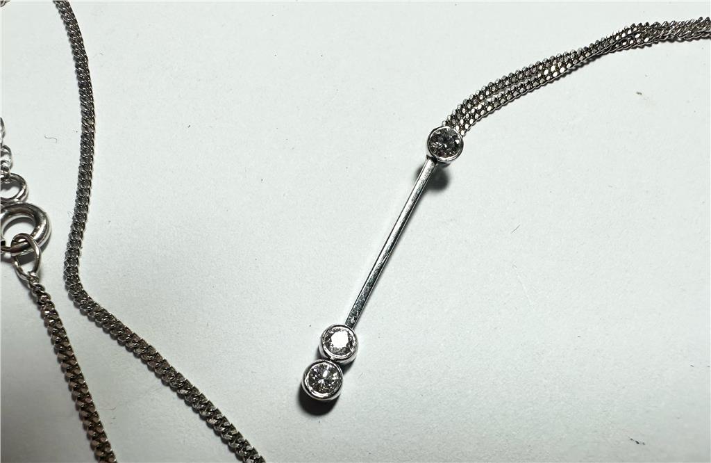 9ct white gold chain with 18ct white gold diamond pendant, showcasing a sparkling pendant on a delicate gold chain.